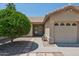 Charming front exterior featuring a small green tree and a covered entrance to the home at 6645 E Preston St, Mesa, AZ 85215