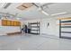 Spacious garage with overhead lighting, storage shelves, and speckled epoxy flooring at 6645 E Preston St, Mesa, AZ 85215