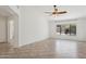 Open-concept living room with tile floors, bright natural light, and a modern ceiling fan at 6645 E Preston St, Mesa, AZ 85215