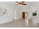 Bright living room with tile floors, neutral walls, ceiling fan and an open floorplan at 6645 E Preston St, Mesa, AZ 85215