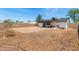 A home's backyard with patio, solar panels and block wall that surrounds the property at 733 E Halifax St, Mesa, AZ 85203