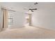 Spacious bedroom with ceiling fan, neutral carpet, and two bright windows at 733 E Halifax St, Mesa, AZ 85203
