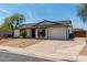 Cozy home featuring a well-kept yard, desert landscaping, and a convenient two-car garage at 733 E Halifax St, Mesa, AZ 85203