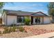 Charming single-level home featuring desert landscaping and a convenient two-car garage at 733 E Halifax St, Mesa, AZ 85203