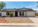 Charming single-level home featuring a low-maintenance desert landscape and a two-car garage at 733 E Halifax St, Mesa, AZ 85203