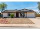 Charming single-level home featuring a low-maintenance desert landscape and a two-car garage at 733 E Halifax St, Mesa, AZ 85203