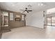 Open living room with neutral walls, tile flooring, and a ceiling fan for comfortable living at 733 E Halifax St, Mesa, AZ 85203