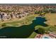Aerial image highlighting the community's golf course and lake surrounded by beautiful houses and palm trees at 7531 W Kimberly Way, Glendale, AZ 85308