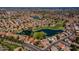 Expansive aerial shot highlighting a golf course community, a blue pond, and well-maintained residential properties at 7531 W Kimberly Way, Glendale, AZ 85308