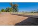 Nice sized backyard with wrought iron fence with views of the green common area and mature shade trees at 7531 W Kimberly Way, Glendale, AZ 85308