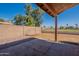 A shot of the backyard featuring a cinder block fence and mature trees at 7531 W Kimberly Way, Glendale, AZ 85308