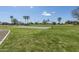 Outdoor basketball court featuring well maintained court on grassy area with palm trees in the background at 7531 W Kimberly Way, Glendale, AZ 85308
