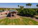 Aerial view of the clubhouse entrance with well-manicured lawns and a glimpse of the surrounding golf course at 7531 W Kimberly Way, Glendale, AZ 85308