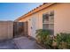 Home exterior featuring desert landscaping, gated entrance, and window with blinds at 7531 W Kimberly Way, Glendale, AZ 85308
