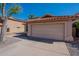Single Gathering house featuring two car garage, desert landscaping, and red tiled roof at 7531 W Kimberly Way, Glendale, AZ 85308
