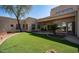 Beautifully landscaped backyard with artificial turf and desert plants create a serene outdoor space at 8540 E Mcdowell Rd # 116, Mesa, AZ 85207