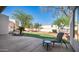 Inviting backyard featuring lush green grass, desert landscaping and comfortable patio furniture at 8540 E Mcdowell Rd # 116, Mesa, AZ 85207