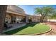 Spacious backyard featuring lush artificial turf, a cozy patio, and desert landscaping at 8540 E Mcdowell Rd # 116, Mesa, AZ 85207