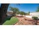 Private backyard featuring artificial turf and desert landscaping, offering a tranquil outdoor retreat at 8540 E Mcdowell Rd # 116, Mesa, AZ 85207