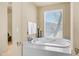 Bright bathroom featuring a luxurious bathtub and natural light creating a tranquil space perfect for relaxation at 8540 E Mcdowell Rd # 116, Mesa, AZ 85207