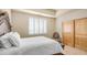 Cozy bedroom featuring a white bed, shuttered windows, and a closet that provides ample space and comfort at 8540 E Mcdowell Rd # 116, Mesa, AZ 85207