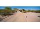Desert property featuring a gravel driveway surrounded by lush native trees and shrubbery at 8540 E Mcdowell Rd # 116, Mesa, AZ 85207