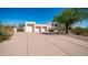 Desert property featuring a spacious driveway and attached three-car garage at 8540 E Mcdowell Rd # 116, Mesa, AZ 85207