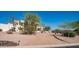 Expansive desert home with lush trees and gravel driveway for natural curb appeal at 8540 E Mcdowell Rd # 116, Mesa, AZ 85207