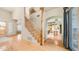 Spacious foyer featuring wood floors, staircase, and views of the kitchen and living area at 8540 E Mcdowell Rd # 116, Mesa, AZ 85207