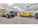 Large garage with ample space, featuring a car and jeep parked inside at 8540 E Mcdowell Rd # 116, Mesa, AZ 85207
