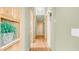 Well-lit hallway with hardwood floors and built-in shelving, blending practical design with a warm ambiance at 8540 E Mcdowell Rd # 116, Mesa, AZ 85207