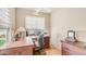 Inviting home office with wooden desk, rolling chair, and natural light, creating a comfortable work environment at 8540 E Mcdowell Rd # 116, Mesa, AZ 85207