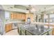Gourmet kitchen featuring stainless steel appliances, a central island, and custom cabinetry at 8540 E Mcdowell Rd # 116, Mesa, AZ 85207