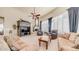 Inviting living room with comfortable seating, a fireplace, and large windows providing natural light at 8540 E Mcdowell Rd # 116, Mesa, AZ 85207