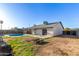 Expansive backyard with lush grass, a sparkling pool, and ample space for outdoor enjoyment at 9009 W Butler Dr, Peoria, AZ 85345