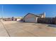 View of the two-car garage, concrete driveway, and fenced yard for added privacy and security at 9009 W Butler Dr, Peoria, AZ 85345