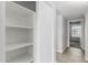 Hallway featuring tile flooring, linen closet, and window at the end of the hall at 9009 W Butler Dr, Peoria, AZ 85345
