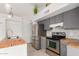 Functional kitchen with stainless steel appliances, butcher block countertops, and ample storage space at 9009 W Butler Dr, Peoria, AZ 85345