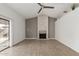 Cozy living room with a striking fireplace, neutral paint, and a ceiling fan for added comfort at 9009 W Butler Dr, Peoria, AZ 85345