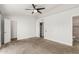 Spacious main bedroom boasts neutral carpet, ceiling fan, two closets, and a door to the bathroom at 9009 W Butler Dr, Peoria, AZ 85345