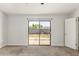 This bedroom features neutral carpet and a sliding glass door that opens to the backyard at 9009 W Butler Dr, Peoria, AZ 85345