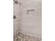 Updated shower features a built-in shampoo nook and gray stone-look tiling at 9009 W Butler Dr, Peoria, AZ 85345