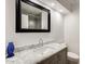 Bathroom vanity with granite countertop and a modern faucet with a decorative blue vase at 9214 N 54Th Ave, Glendale, AZ 85302