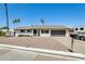 Charming single-story white home with a gravel yard, and a black mailbox and garage door at 9214 N 54Th Ave, Glendale, AZ 85302