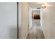 Hallway with wood-look tile flooring and white walls that leads to rooms with neutral decor at 9214 N 54Th Ave, Glendale, AZ 85302