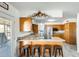 Eat in kitchen has warm wood cabinets, stainless appliances, and an island with barstool seating at 9214 N 54Th Ave, Glendale, AZ 85302