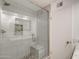 A shower enclosure with gray stone floors and walls, and a built-in bench at 9214 N 54Th Ave, Glendale, AZ 85302