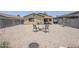 Large backyard featuring a low-maintenance desert landscape, privacy walls, and covered patio at 941 E Desert Moon Trl, San Tan Valley, AZ 85143