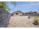 Spacious desert-landscaped backyard, enclosed by a block fence, with a covered patio at 941 E Desert Moon Trl, San Tan Valley, AZ 85143