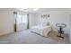Expansive bedroom with a king bed and large window with sheer curtains allowing natural light to filter in at 941 E Desert Moon Trl, San Tan Valley, AZ 85143